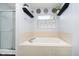 Bathroom with white tile features a bathtub and a window to provide natural light at 6134 Chadsworth Way, Lawrence, IN 46236