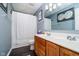 Cozy bathroom with a dual vanity, silver fixtures, framed mirror, and a shower with a white curtain at 6134 Chadsworth Way, Lawrence, IN 46236