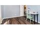 Bedroom with wood floors features a desk and a chair at 6134 Chadsworth Way, Lawrence, IN 46236