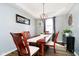 Elegant dining room with a modern light fixture and a beautiful wood table at 6134 Chadsworth Way, Lawrence, IN 46236
