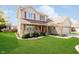 Beautifully landscaped front yard with a lush green lawn and established landscaping at 6134 Chadsworth Way, Lawrence, IN 46236