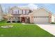 Charming two-story home featuring a well-manicured lawn and a welcoming front porch at 6134 Chadsworth Way, Lawrence, IN 46236