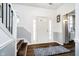 Inviting foyer with hardwood floors, neutral paint, and a staircase leading to the upper level at 6134 Chadsworth Way, Lawrence, IN 46236