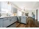 Modern kitchen with gray cabinets, stainless steel appliances, and open view to living room at 6134 Chadsworth Way, Lawrence, IN 46236
