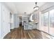 Modern kitchen featuring gray cabinets, a breakfast bar, and stainless steel appliances at 6134 Chadsworth Way, Lawrence, IN 46236