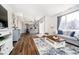Open-concept living space flowing into a stylish kitchen with hardwood floors and ample natural light at 6134 Chadsworth Way, Lawrence, IN 46236