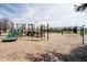 Community playground features a slide, swings, climbing structures, and a soft wood-chip ground at 6134 Chadsworth Way, Lawrence, IN 46236