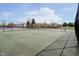Outdoor community tennis court with green surface, surrounded by a black chain-link fence at 6134 Chadsworth Way, Lawrence, IN 46236