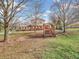 Inviting backyard featuring a charming porch swing and a spacious, well-maintained lawn at 6347 St Joe Dr, Indianapolis, IN 46217