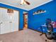 Comfortable bedroom with blue accent wall, carpeted flooring, and view of hallway at 6347 St Joe Dr, Indianapolis, IN 46217