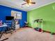 Bright bedroom with blue and green walls, large window, and ceiling fan at 6347 St Joe Dr, Indianapolis, IN 46217