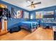 Spacious blue bedroom featuring wood floors, flags, and natural light from windows at 6347 St Joe Dr, Indianapolis, IN 46217