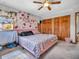 Well lit bedroom, with vibrant floral wallpaper and a pink bed frame at 6347 St Joe Dr, Indianapolis, IN 46217