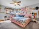 Bright bedroom with floral wallpaper, fan, pink bed, and matching cat tree at 6347 St Joe Dr, Indianapolis, IN 46217