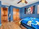 Blue bedroom showcasing hardwood floors, closet doors, and flag decorations at 6347 St Joe Dr, Indianapolis, IN 46217