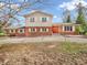 Charming two-story brick home featuring a bright red front door and classic white shutters at 6347 St Joe Dr, Indianapolis, IN 46217