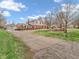 Spacious home exterior with a large driveway, expansive yard, and a detached garage at 6347 St Joe Dr, Indianapolis, IN 46217
