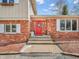A bright red door welcomes you to this beautiful home with classic brick and white trim at 6347 St Joe Dr, Indianapolis, IN 46217
