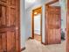 Hallway view featuring hardwood doors and trim, with an open bathroom view at 6347 St Joe Dr, Indianapolis, IN 46217