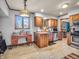 A nice kitchen with a view of the backyard, stainless steel dishwasher, and wooden cabinets at 6347 St Joe Dr, Indianapolis, IN 46217