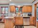 Charming kitchen with wood cabinets and stainless steel dishwasher plus a view to the backyard at 6347 St Joe Dr, Indianapolis, IN 46217