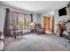 Inviting living room featuring a fireplace, plush carpeting, and a large window with natural light at 6347 St Joe Dr, Indianapolis, IN 46217