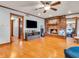 Cozy living room features a brick fireplace, wood flooring and ceiling fan at 6347 St Joe Dr, Indianapolis, IN 46217