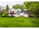 Spacious backyard with lush lawn, mature trees, and a patio perfect for outdoor enjoyment at 650 Forest Blvd, Indianapolis, IN 46240