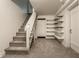 Finished basement with carpeted stairs, open shelving, and ample storage space at 650 Forest Blvd, Indianapolis, IN 46240