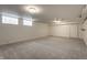 Spacious unfinished basement featuring neutral carpet, glass block windows, and ample lighting at 650 Forest Blvd, Indianapolis, IN 46240
