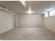 Open basement area with neutral carpet, bright lighting, and potential for customization at 650 Forest Blvd, Indianapolis, IN 46240