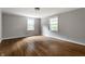 Spacious bedroom with gleaming hardwood floors, two large windows, and neutral wall color at 650 Forest Blvd, Indianapolis, IN 46240
