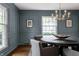 Dining room with a modern chandelier, round table, and elegant wall paneling at 650 Forest Blvd, Indianapolis, IN 46240