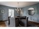 Formal dining room boasts a modern chandelier and a round table for sophisticated gatherings at 650 Forest Blvd, Indianapolis, IN 46240