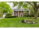 Charming two-story brick home boasts a landscaped yard, a covered porch, and classic architectural details at 650 Forest Blvd, Indianapolis, IN 46240