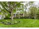 Classic brick home with a spacious lawn, mature trees, and well-manicured landscaping at 650 Forest Blvd, Indianapolis, IN 46240