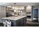 Bright, modern kitchen with stainless steel appliances, a marble island, and elegant pendant lighting at 650 Forest Blvd, Indianapolis, IN 46240