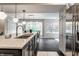 Bright kitchen with a large center island, stainless steel refrigerator, and open dining area at 650 Forest Blvd, Indianapolis, IN 46240