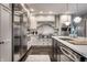 Well-lit kitchen with stainless steel appliances, white subway tile, and a center island with seating at 650 Forest Blvd, Indianapolis, IN 46240