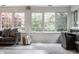 Bright living room features large windows offering natural light, with a cozy couch and stylish decor at 650 Forest Blvd, Indianapolis, IN 46240