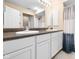Bathroom featuring dual sinks with white cabinets and a large mirror at 652 Blossom Dr, Avon, IN 46123