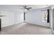 Spacious bedroom featuring light blue walls, carpet, a window, glass doors, and a double door closet at 652 Blossom Dr, Avon, IN 46123