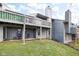 Back of this two-story home with patio and deck is surrounded by a lush green lawn at 652 Blossom Dr, Avon, IN 46123