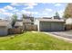 Exterior view of the condo building with a two-car garage and well-maintained green lawn on a sunny day at 652 Blossom Dr, Avon, IN 46123