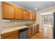 Well-lit kitchen with stainless steel appliances, wood cabinetry, and a view to the outdoor patio at 652 Blossom Dr, Avon, IN 46123
