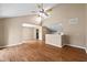 Inviting living room with hardwood floors, ceiling fan, high ceilings, and an open layout flowing into the kitchen at 652 Blossom Dr, Avon, IN 46123