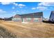 View of the back of a single-Gathering home with a large backyard and a patio at 7111 Lillian Pl, Cumberland, IN 46229