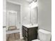 Bright bathroom with a single vanity, modern faucet, and toilet, with views to the hallway at 7111 Lillian Pl, Cumberland, IN 46229