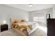 Relaxing bedroom with a tufted headboard, neutral walls, plush carpet and a sun-filled window at 7111 Lillian Pl, Cumberland, IN 46229