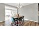 Dining area features a modern table and chairs, and is open to the living room at 7111 Lillian Pl, Cumberland, IN 46229